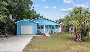 This charming house features parking for 3 cars, a basketball hoop and a porch.