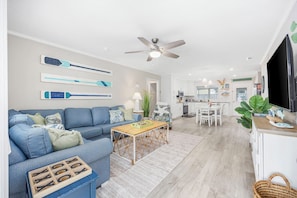 The open-concept design seamlessly connects to the kitchen and dining area.