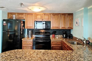 Kitchen is stocked with everything you need to feel at home from spices to silverware.