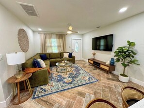 Modern Boho Living Room with Fan,  wrap around Sofa and Large