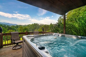 Hot tub with view of Mt LeConte and surrounded by lush trees