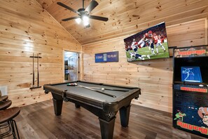Enjoy the pool table, stand up arcade with classic games and 65" smart TV 