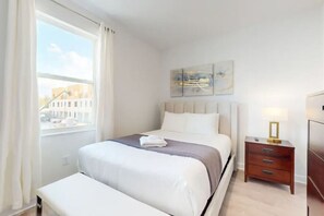 The bedroom was a peaceful retreat, showcasing a sumptuous king-size bed with plush, crisp linens, enhanced by soft bedside lighting and elegant artwork gracing the walls.