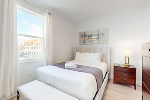 The bedroom was a peaceful retreat, showcasing a sumptuous king-size bed with plush, crisp linens, enhanced by soft bedside lighting and elegant artwork gracing the walls.