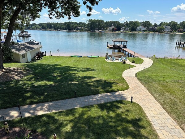 Walk out to the private beach, firepit, gazebo over the water and floating dock 