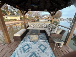 Comfortable Sofa, Bench and Gas Firepit on the gazebo over the lake.