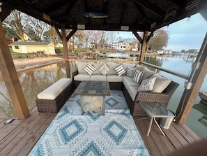 Comfortable Sofa, Bench and Gas Firepit on the gazebo over the lake.