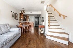 Open plan living, dining, and kitchen with stairs to upper level with bedrooms