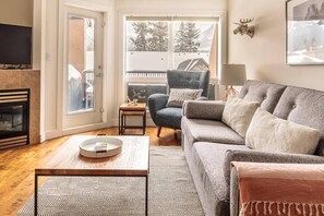 Living room opens onto the lovely south-facing deck with BBQ and lounge seating