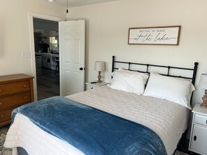 Main bedroom #1 w/ queen size bed, dresser/nightstands, large TV on wall