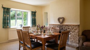 Dine together beside the decorative fireplace