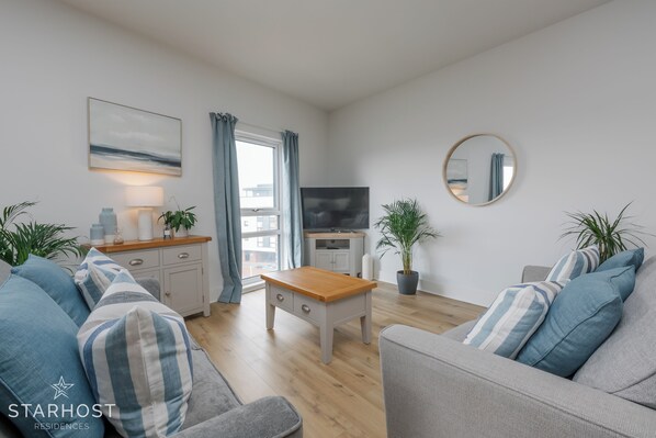 The lounge has a comfortable sofa bed and a smart TV