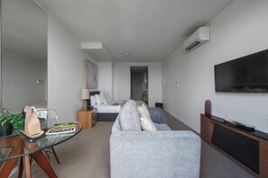 The open floor plan allows the natural light to pour into nearly every corner of this studio apartment. 