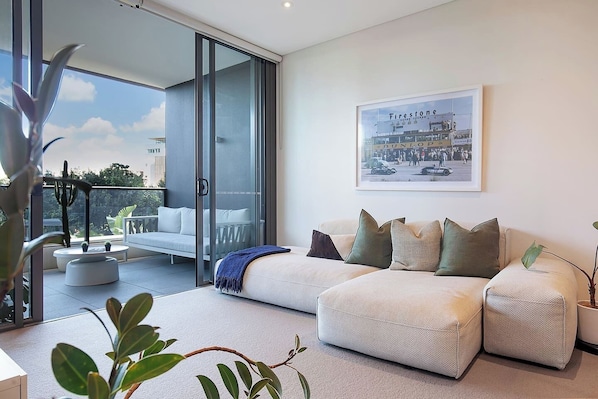The open-plan living and dining area flows to the balcony, creating a lovely transition between indoors and out.