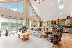 The heart of the home boasts vaulted ceilings and an open layout, combining the living room, dining area, and spacious kitchen—ideal for gathering with loved ones. Soak in stunning views of Big Blake Lake, the bonfire pit, and shoreline while keeping an ey