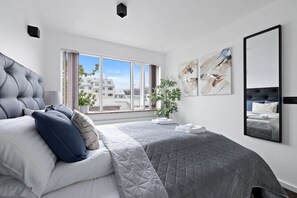 Experience ultimate comfort in the luxurious master bedroom, featuring a first-class king-size bed adorned with high-quality linen and fluffy pillows.