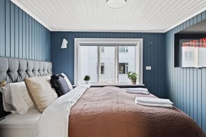 Relax and unwind in this luxurious bedroom featuring a king-sized bed and a wall-mounted TV. Experience ultimate comfort in this spacious bedroom with a king-sized bed and a sleek TV mounted on the wall. Sleep like royalty in this stylish bedroom boasting