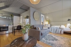 Make Yourself at Home in Our Spacious Living Room, Complete with a Big TV and Cozy Couch