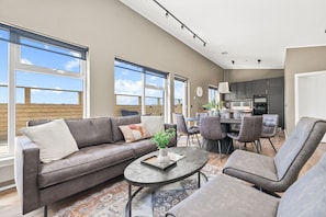Enjoy breathtaking panoramic views of the Icelandic landscape from this modern and spacious living area.
