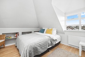 This inviting bedroom offers a serene and tranquil escape.