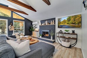 living room: gas fireplace (remote operated), 65" Smart TV, record player