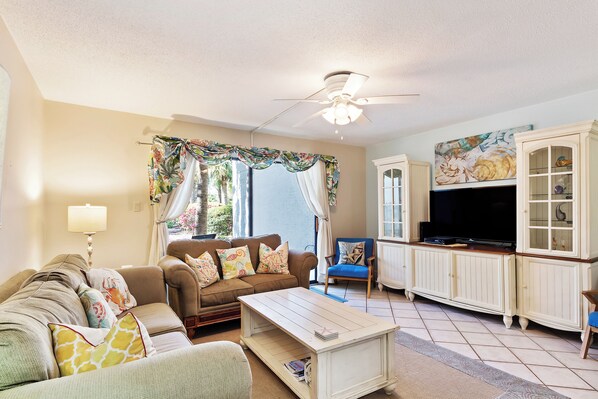 Living room with smart TV and ground floor patio.