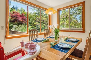 Bright dining space with lush garden views—plus a high chair for the little one.
