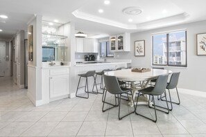 Seating for 6 at the dining table with 4 adjacent bar stools for additional seating