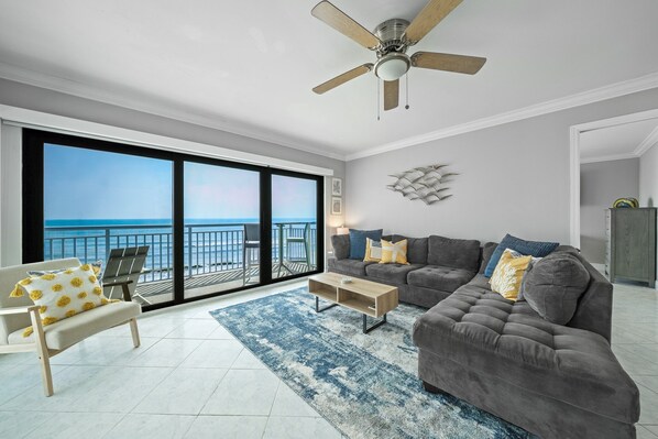 Unwind after a day at the beach on the comfortable sectional sofa in the oceanfront living room
