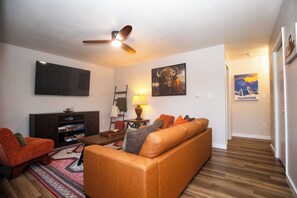 Living room view leading to hallway with bedrooms and bathroom