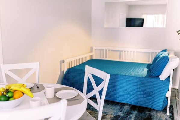 Embrace serenity in our bedroom sanctuary. The bed beckons amidst elegant night shades, flanked by chic side tables. The window frames a view that invites natural light, creating a peaceful haven for restful nights and tranquil mornings.
