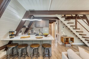 Modern kitchen with barstool seats.