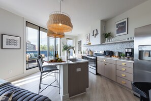 Fully equipped kitchen with barstool seating at the island counter.