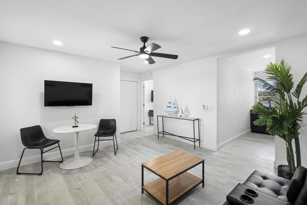 Modern and cozy space with a table with stylish chairs, and a flat-screen TV.