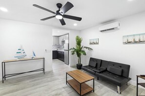 Modern and cozy space featuring a minimalist sofa and ceiling fan