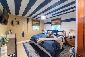 Blue & white shiplap in the primary suite evokes a feeling of being out at sea
