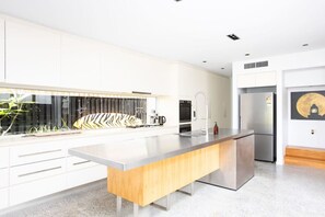 Fully equipped kitchen with all modern appliances and a coffee machine.