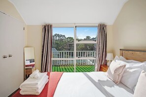 There is plenty of natural light streaming into the bedroom through the ranch slider doors.