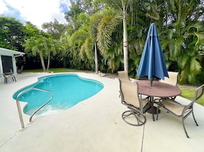 Pool with two large seating areas. Two lounge chairs not pictured.