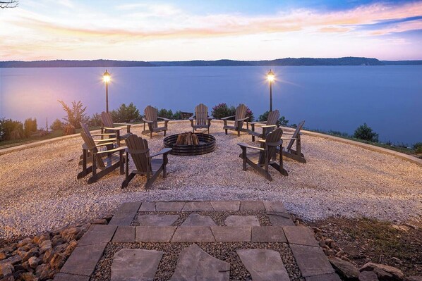 In the evening, laugh, tell stories, and make memories around the firepit with plentiful Adirondack chairs and illuminated with quaint streetlamp-style lights