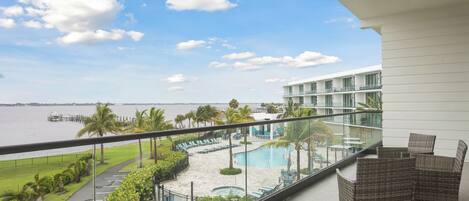 Scenic balcony views overlooking the Indian River, resort-style pool, marina, and walking trails.