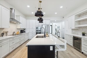 Sleek, modern kitchen featuring a large island.