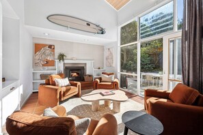 The lower living area features a charming fireplace - a cosy haven for cooler evenings