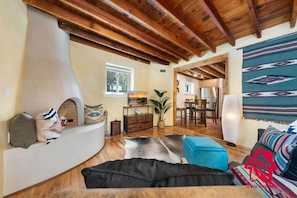 Warm rustic home with wooden beam ceilings and fireplace.