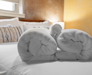 Elegant bedroom with charming towel elephant decorations.