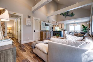 The open layout seamlessly connects the living room to the kitchen, creating a welcoming space for relaxation and socializing.