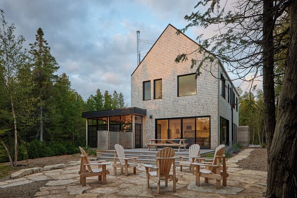 A cozy outdoor fire pit with Adirondack chairs for memorable evenings under the stars.
