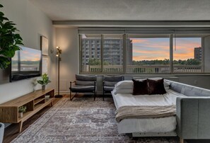 You’ll love the comfort of this inviting living room, where plush pillows and a warm blanket are ready for you. Picture yourself wrapping up after a long day, feeling perfectly at ease in this cozy space.