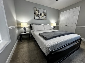 Sleep soundly in a cozy bedroom with a plush queen-size bed for ultimate comfort!