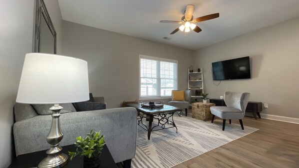 Chill out in our inviting living room, complete with a plush couch, TV, and a stylish center table for snacks!